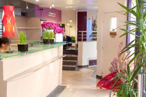 a lobby of a flower shop with pink flowers at Le Hameau de Passy in Paris