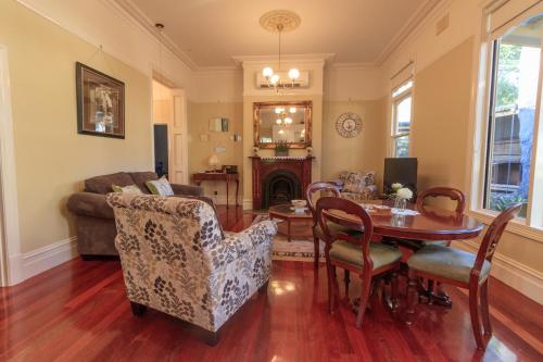 a living room with a table and a couch at The Oaks Lilydale Accommodation in Lilydale