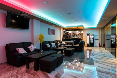 a lobby with couches and tables and a tv at SPA Kompleks Raiski Kat in Dimitrovgrad