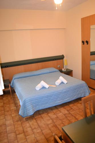 Postel nebo postele na pokoji v ubytování Hotel Smeraldo