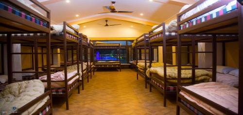 a group of bunk beds in a room at La Bellevue (Club & Resort) in Rāmnagar