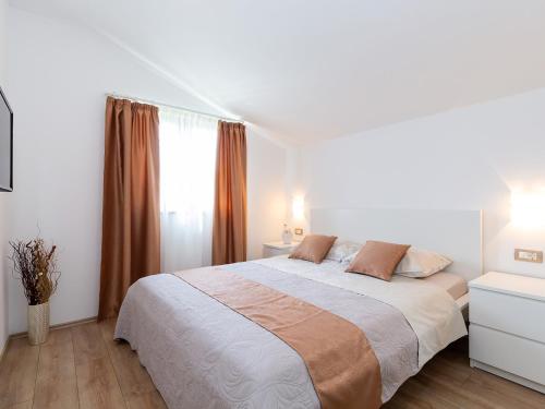 Un pat sau paturi într-o cameră la Apartments Gioia