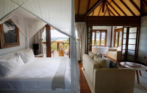 a bedroom with a bed and a living room at Sentidos Beach Retreat in Miramar