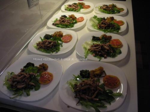 a table with many plates of food on it at Casa vacanze La Meridiana in Donnalucata
