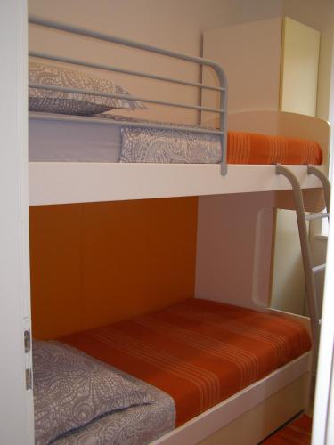 a bunk bed room with two bunk beds at Harbor terrace - two bedroom apartment in Murter