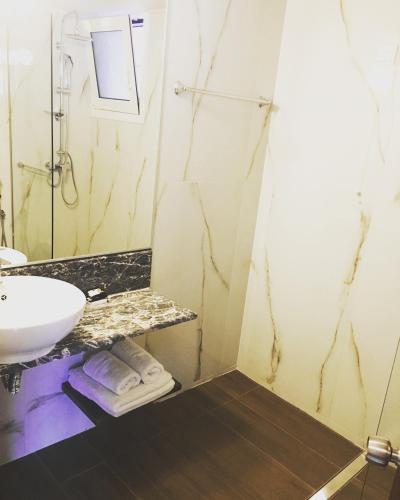 a bathroom with a sink and a mirror at 12 Olympian Gods in Platamonas