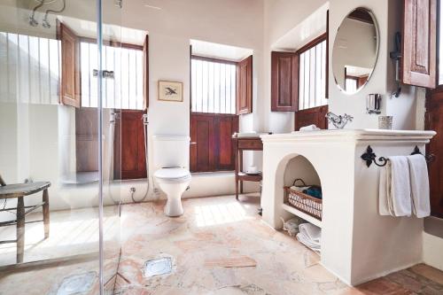 a bathroom with a toilet and a glass shower at XVA Art Hotel in Dubai
