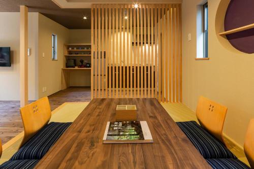 a dining room with a table and two chairs at Hisashi in Kyoto