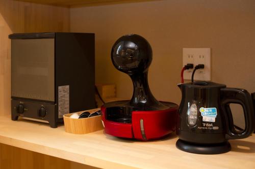 a blender sitting on a counter next to a microwave at Hisashi in Kyoto