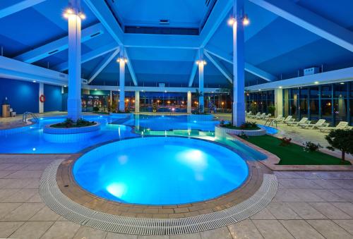 a large pool in a building at night at Recreational resort Zavidovo in Zavidovo