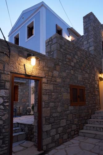a stone building with a light on top of it at Kaminos Boutique Hotel in Symi