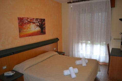 Postel nebo postele na pokoji v ubytování Hotel Smeraldo