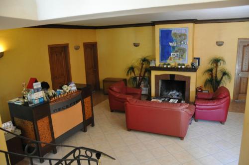 a living room with couches and a fireplace at Mr. Dim Exclusive Apart Hotel in Göcek