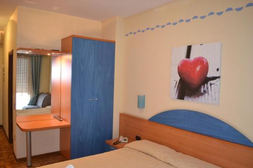 Postel nebo postele na pokoji v ubytování Hotel Smeraldo