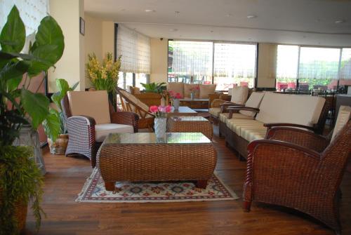 a lobby with couches and chairs and a table at Sunday Beach Hotel in Kusadası