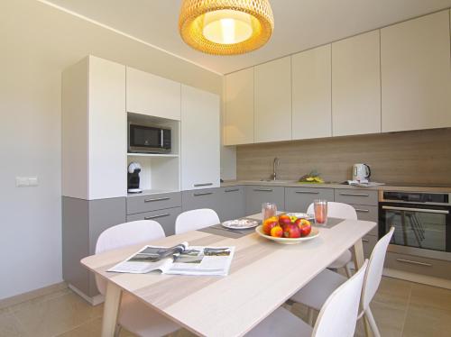 a kitchen with a table with a bowl of fruit on it at Nidos Namai in Nida