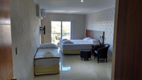 a bedroom with a bed and a desk and a chair at Ivy in Resistencia