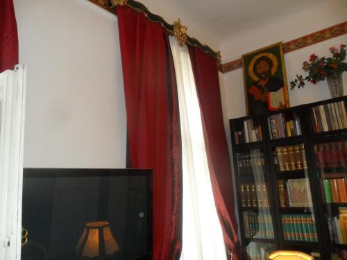 a living room with a tv and a red curtain at Luxury near Castle in Vienna