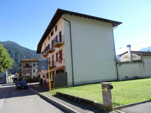 a large white building on the side of a street at Hotel Galles in Paluzza
