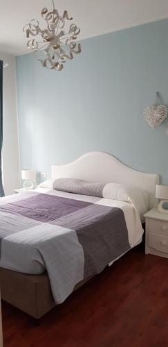 a bedroom with a bed and a chandelier at Le Casette Di Osvaldo in Lecco