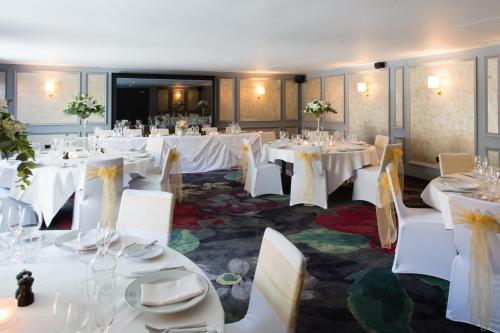 a banquet room with white tables and chairs at Hotel Du Vin Stratford in Stratford-upon-Avon