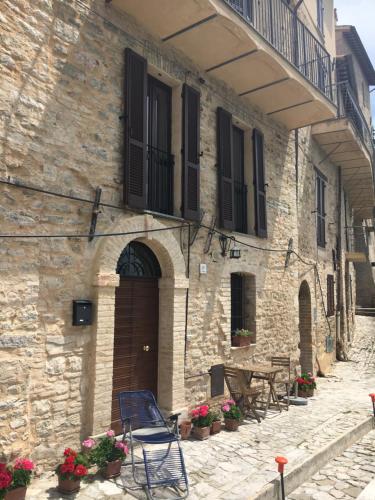 an old stone building with a table and chairs at Casa Camilli in Nocera Umbra