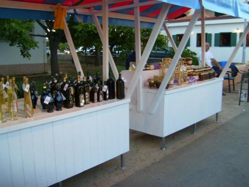 a bunch of bottles of wine sitting on display at Apartmani Luka in Vir