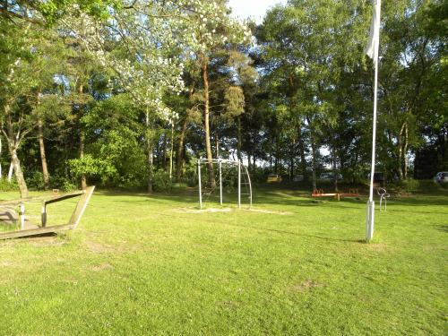 a park with a swing set in the grass at Bungalows Bospark te Stramproy in Stramproy