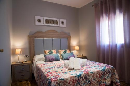 a bedroom with a large bed with two pillows at El Pilar Home in Córdoba