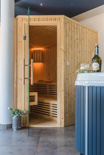 a wooden enclosure with a bottle of wine at Apartments Bego Spa & Wellness in Crikvenica