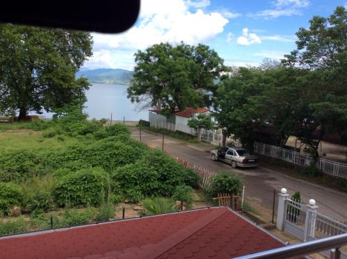 a view from a balcony of a street and a lake at Apartment Slavica in Star Dojran