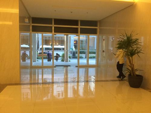 a person standing in a lobby with a plant at Newport City Condo near Manila Airport Terminal 3 in Manila