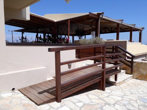 a table and benches on the side of a building at Althea Apartments in Katakolon