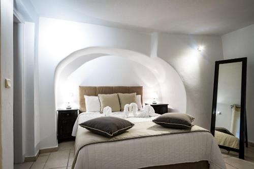 a bedroom with a large bed with an arched ceiling at Galaxy Suites & Villas in Imerovigli
