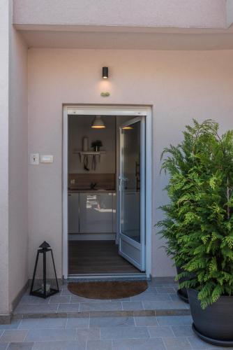 a sliding glass door leading to a kitchen at Apartments Bego Spa & Wellness in Crikvenica