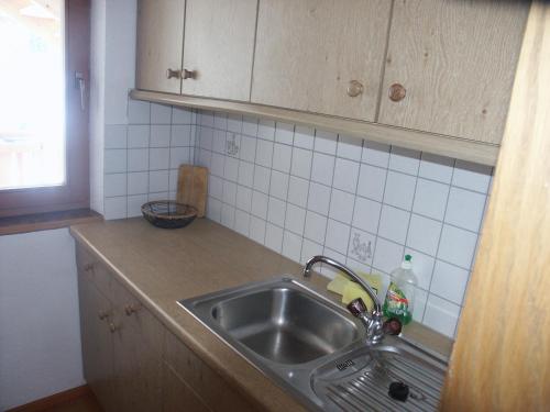 a kitchen with a sink and a counter top at Ferienwohnungen Steidl in Innervillgraten