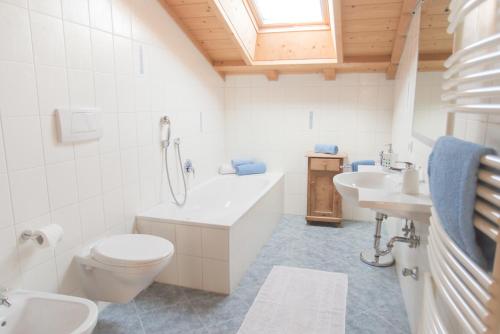 ein Badezimmer mit einem WC, einer Badewanne und einem Waschbecken in der Unterkunft Tollhof in Bozen