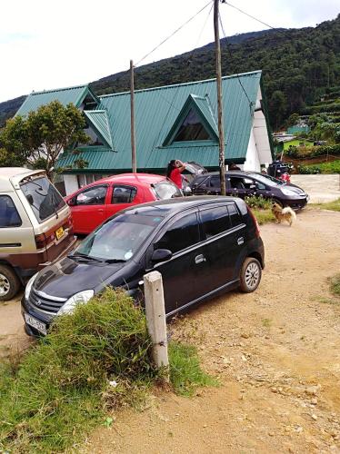 a black car parked in a parking lot at White house in Nuwara Eliya