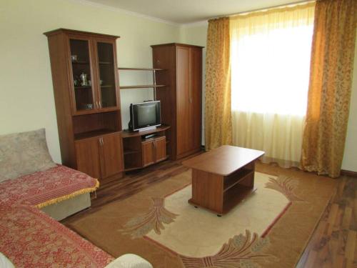 a living room with a couch and a tv at Гостевой дом "Светлана" in Cholpon-Ata