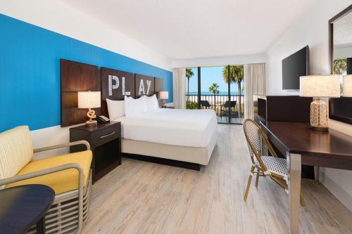 a hotel room with a bed and a desk at Sirata Beach Resort in St. Pete Beach