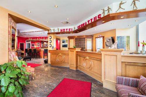 a bar in a restaurant with a red rug at Hotel Servatius in Cologne