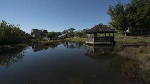 a gazebo sitting on top of a river at Pousada das Nascentes in Catas Altas