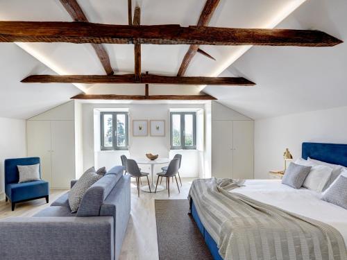 a bedroom with a bed and a couch and a table at Porto Downtown Lovers Suites: Bombarda 451 in Porto