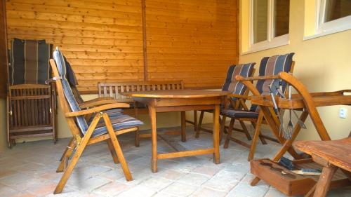 a wooden table and chairs on a patio at Chalupa u kostela in Lukov