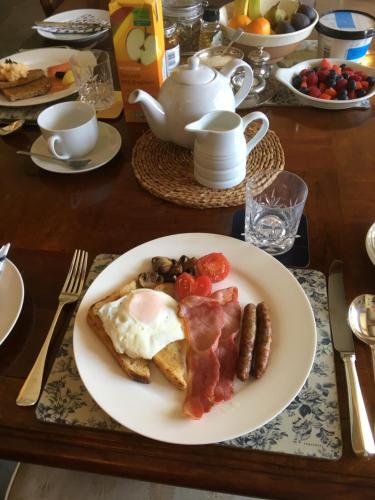 a plate of breakfast food on a table at Higher Melcombe Manor in Ansty