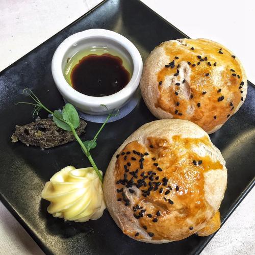 a black plate with two buns and a dipping sauce at The Barnsdale, Rutland in Oakham