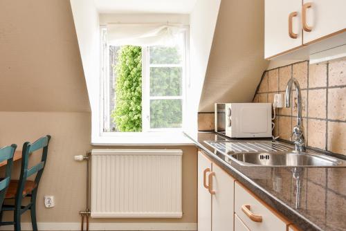 a kitchen with a sink and a window at Boende Visby in Visby