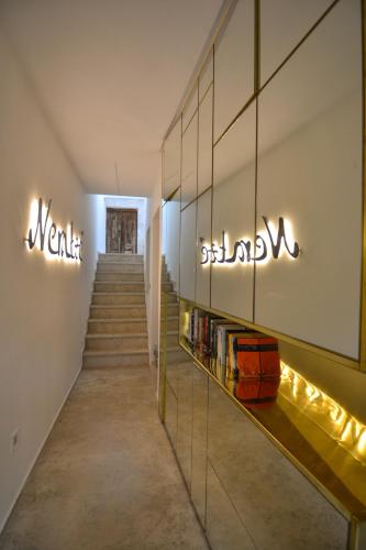 a hallway with stairs and signs on the wall at Neratze Hammam Suites in Rethymno Town