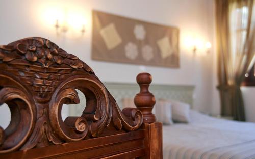 a close up of a wooden bed in a bedroom at Iapetos Village in Symi
