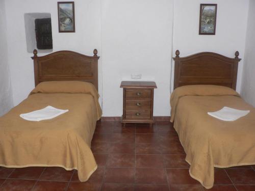 En eller flere senger på et rom på Cortijo la Colá